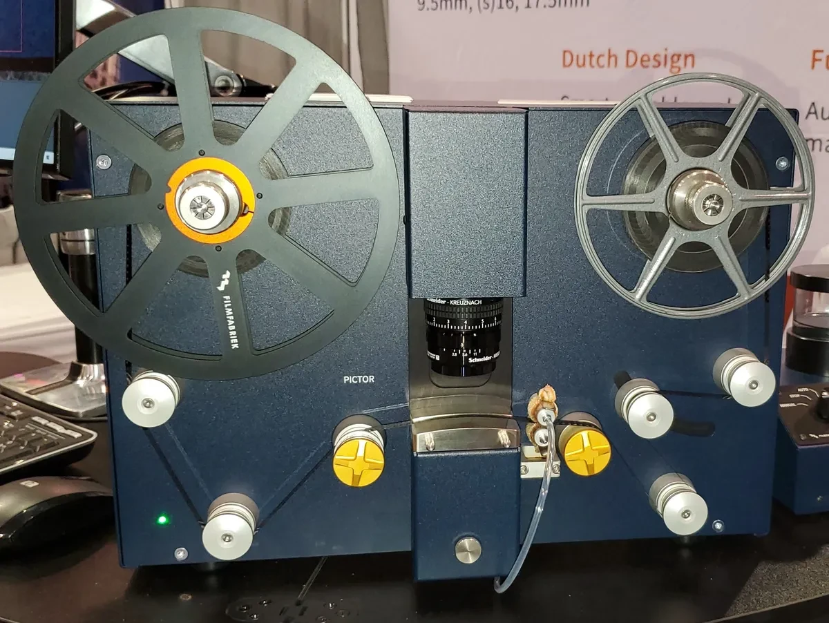 Close-up of a vintage film editing machine with reels and knobs.